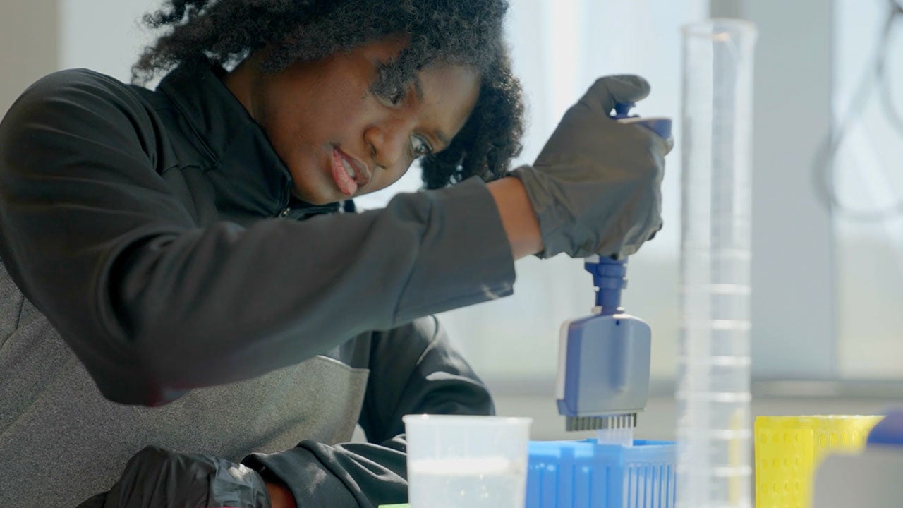 Photo of student using dropper pushing liquid into a test tube