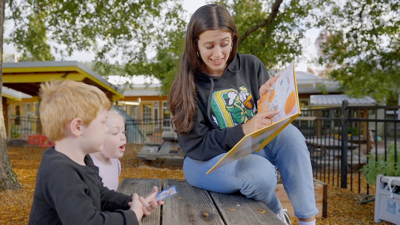 Photo of student reading to children