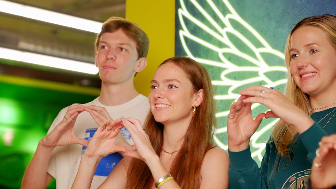 Students showing their "O" in the Welcome Center