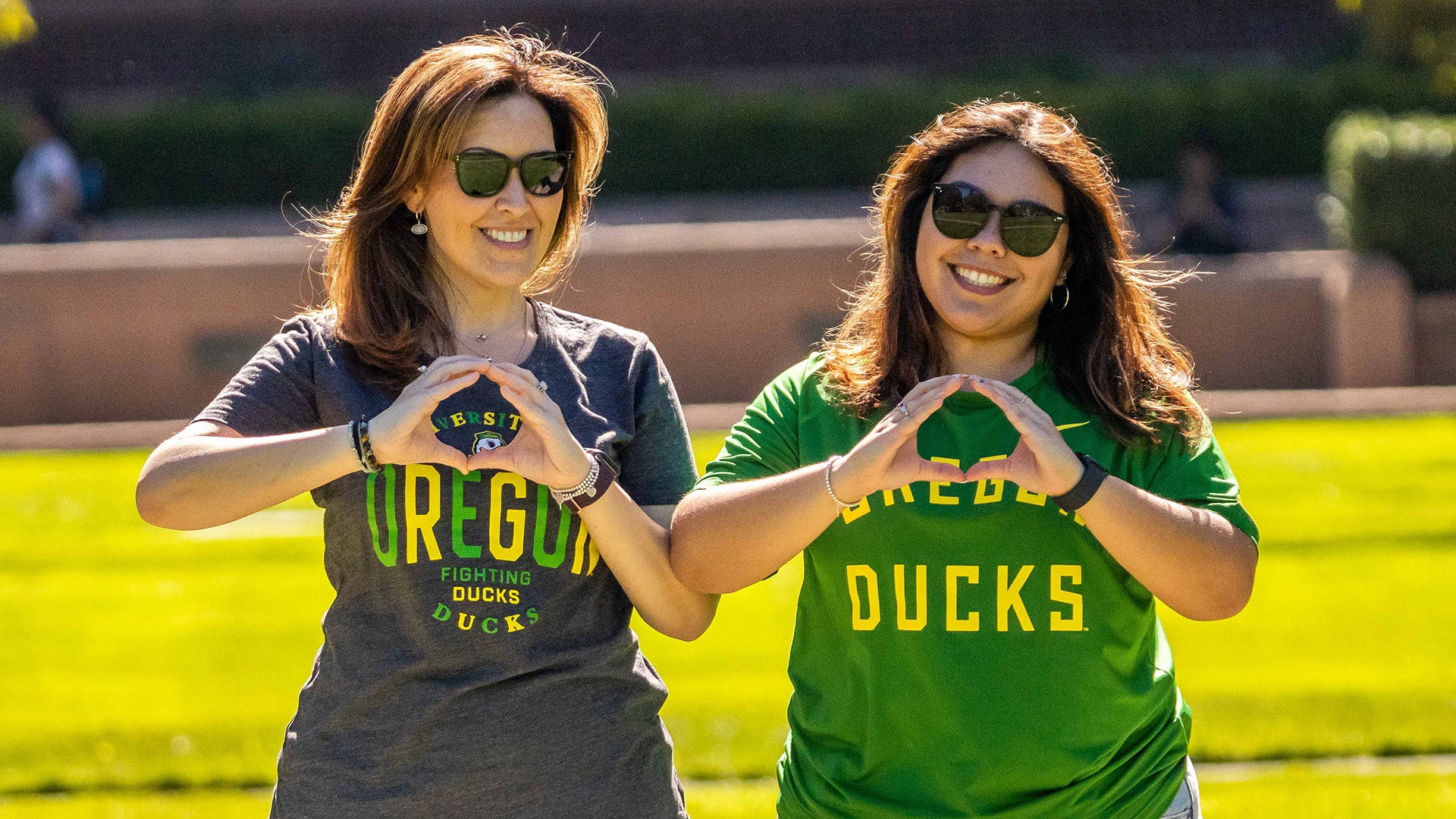 Two people making the "O" with their hands